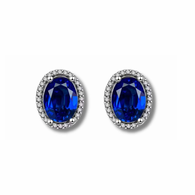 Aretes Aurora de Plata 925 con circonia ovalada azul y halo de circonias brillantes.
