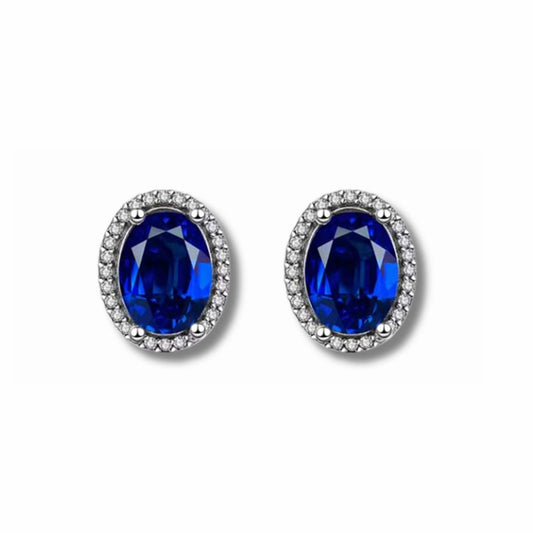 Aretes Aurora de Plata 925 con circonia ovalada azul y halo de circonias brillantes.