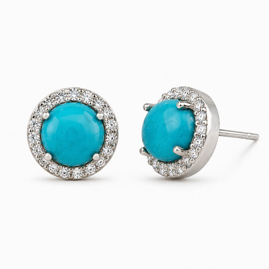 Aretes de Plata Ley 925 con turquesa redonda y halo de circonias brillantes, diseño clásico tipo stud.